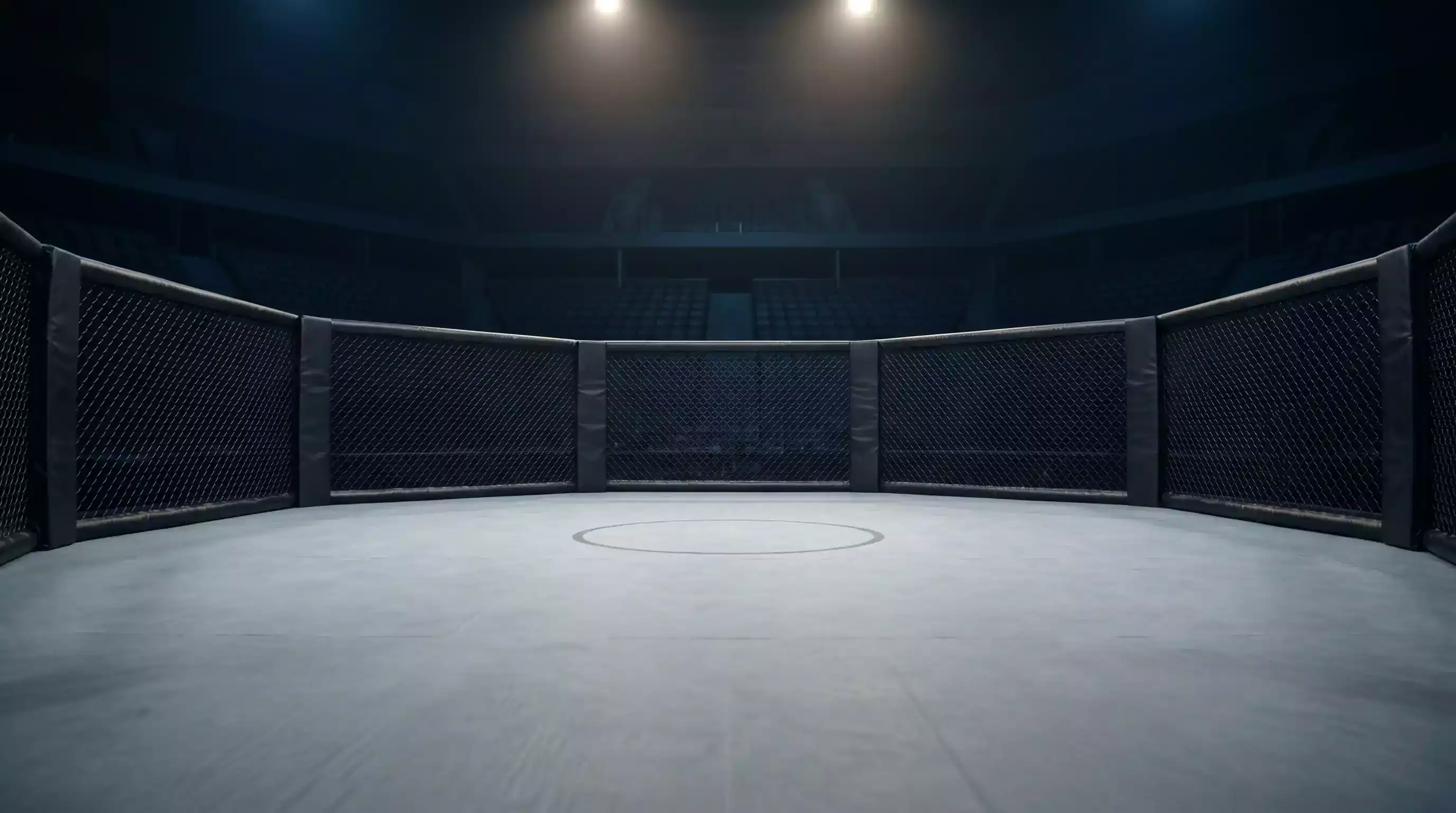 Empty UFC octagon cage from a low angle, canvas illuminated, photographed before a Fight Night card
