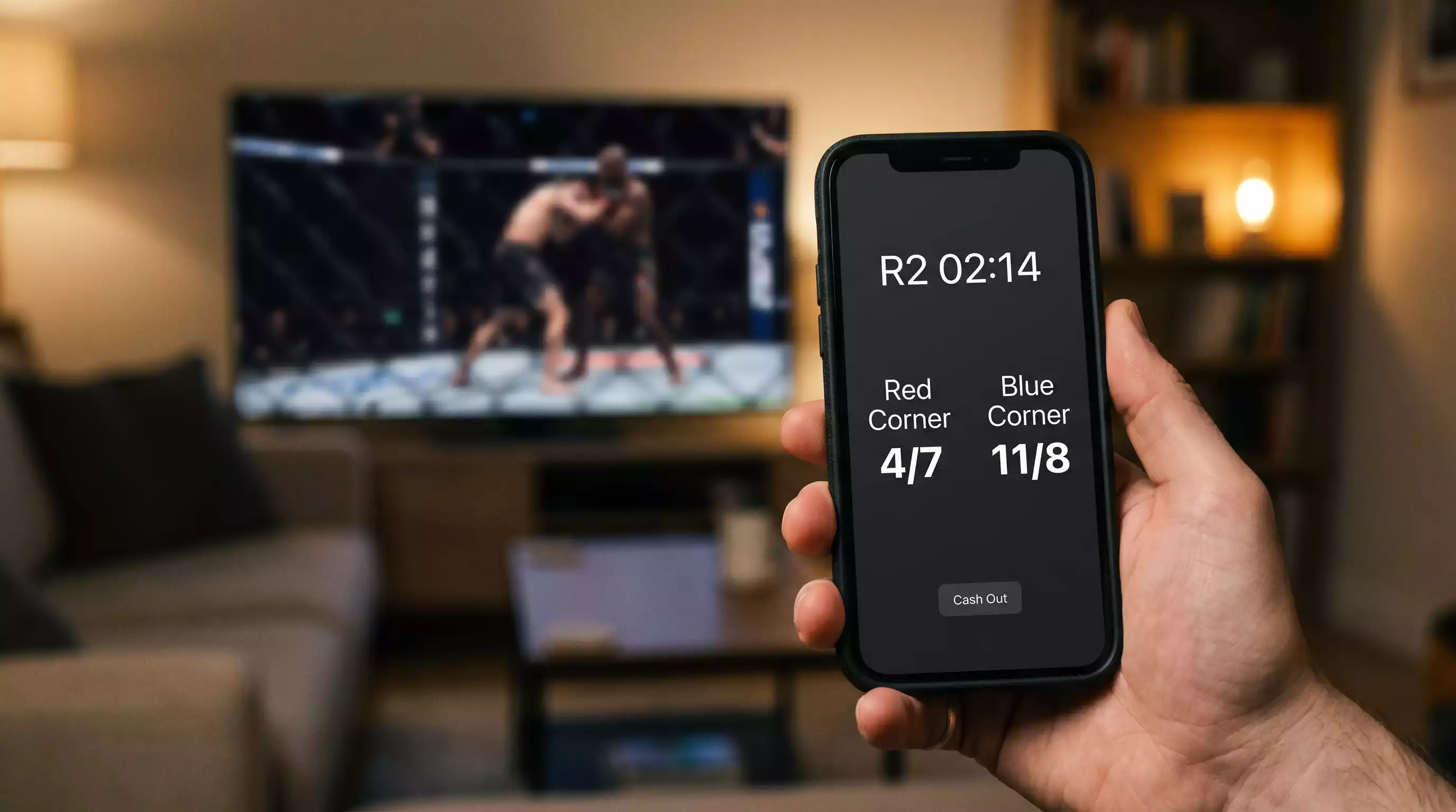 Smartphone displaying live in-play UFC odds between rounds during a televised Fight Night broadcast